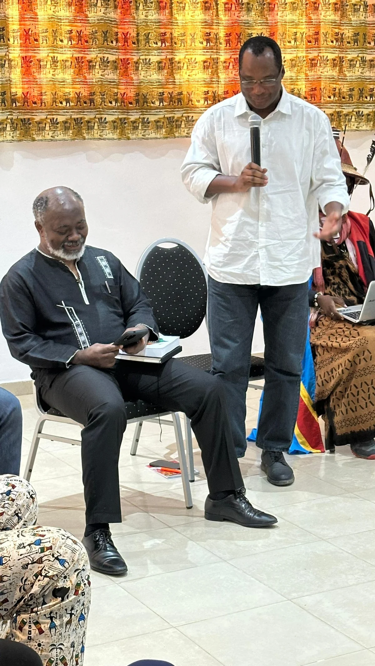 Jean-Paul Sagadou speaking into a microphone