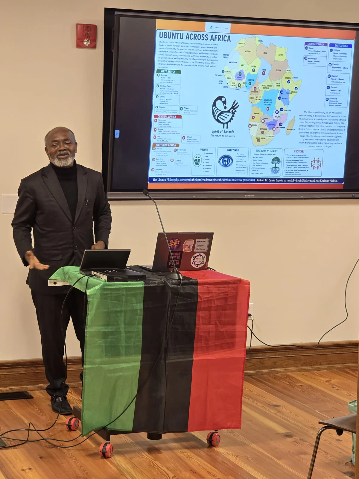 Dr. Lagoke beside the Ubuntu map