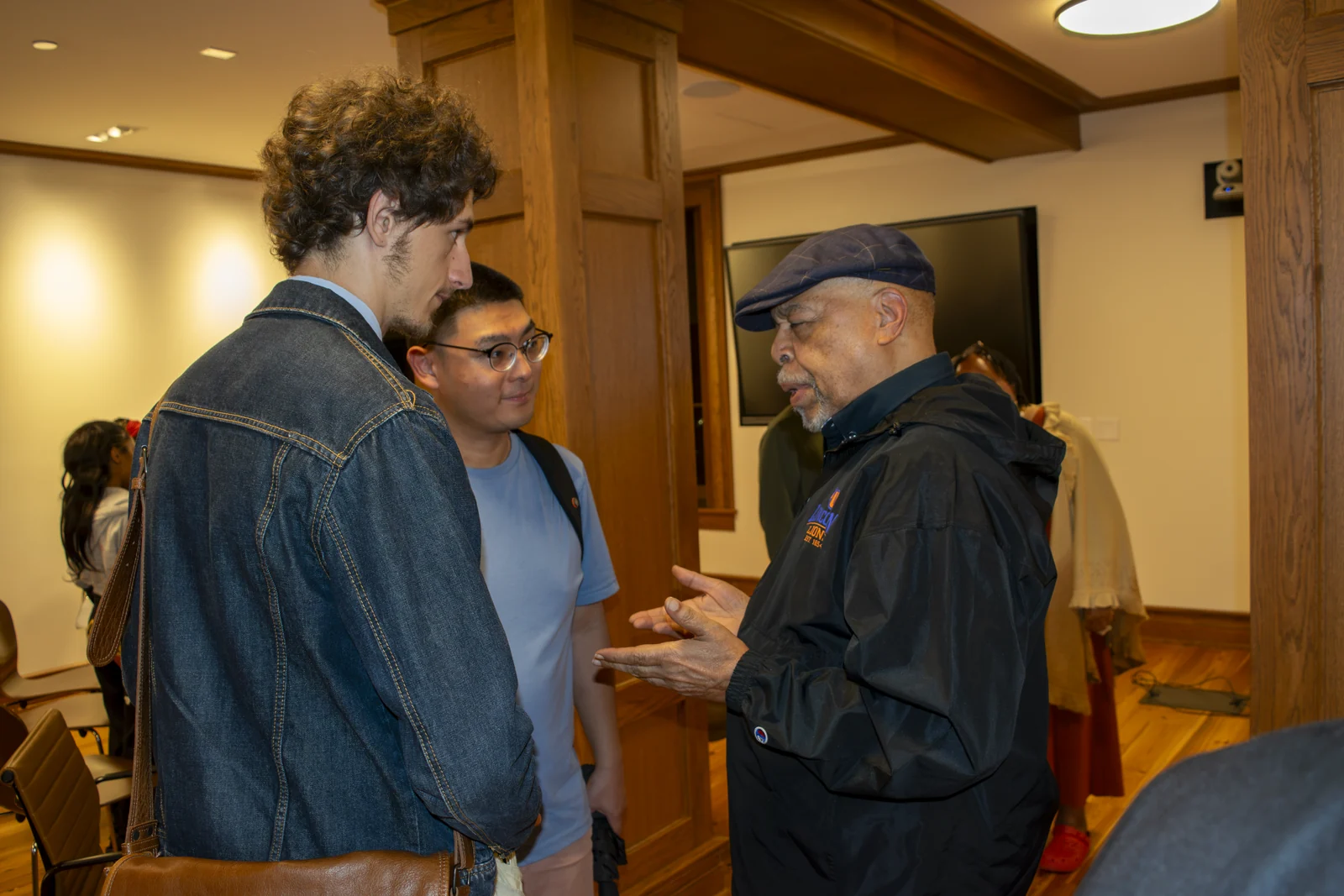 Dr. Zizwe Poe, founder of the Pan-Africana Studies Program at Lincoln University, discusses the lecture with students.