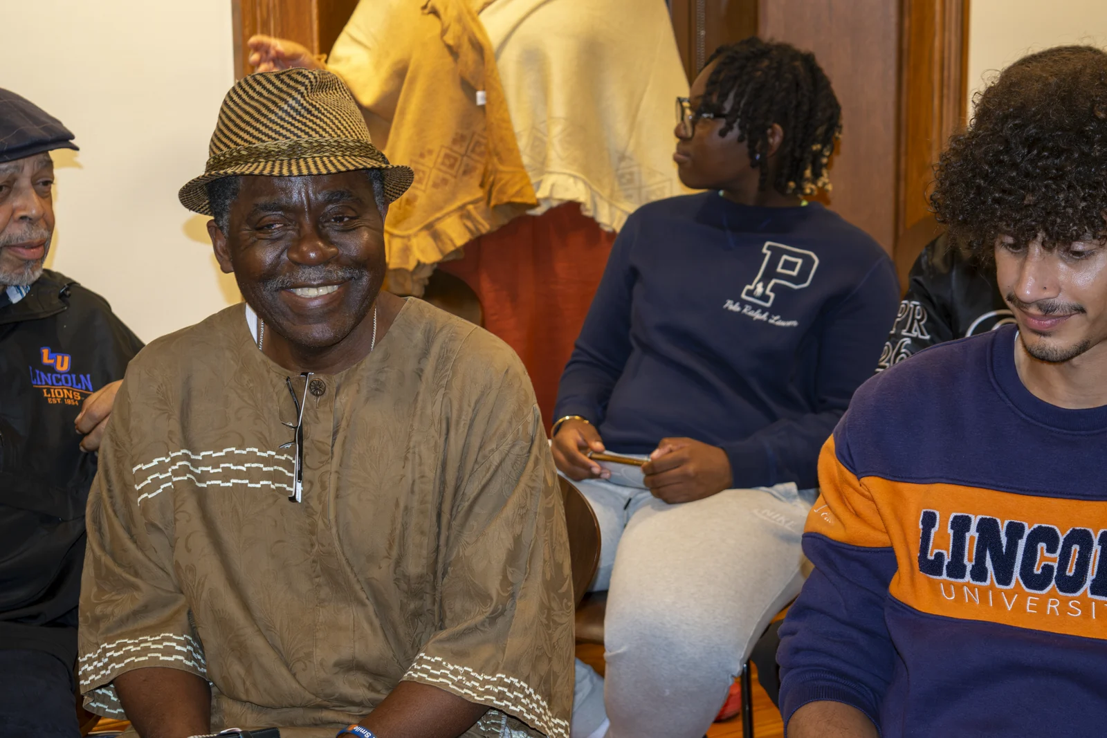 Participants at the September 21 gathering: Dr. Michael Ayewoh, wearing a hat; Adam Green, a student in anthropology; and Morgan Mathison, a student in Pan-Africana Studies, in the background.